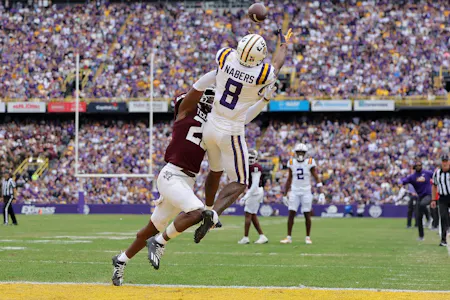 Malik Nabers of the LSU Tigers catches the ball for a touchdown as Demani Richardson of the Texas A&M Aggies defends during the second half at Tiger Stadium. Nabers is viewed as one of the top prospects by the 2024 NFL Draft odds.
