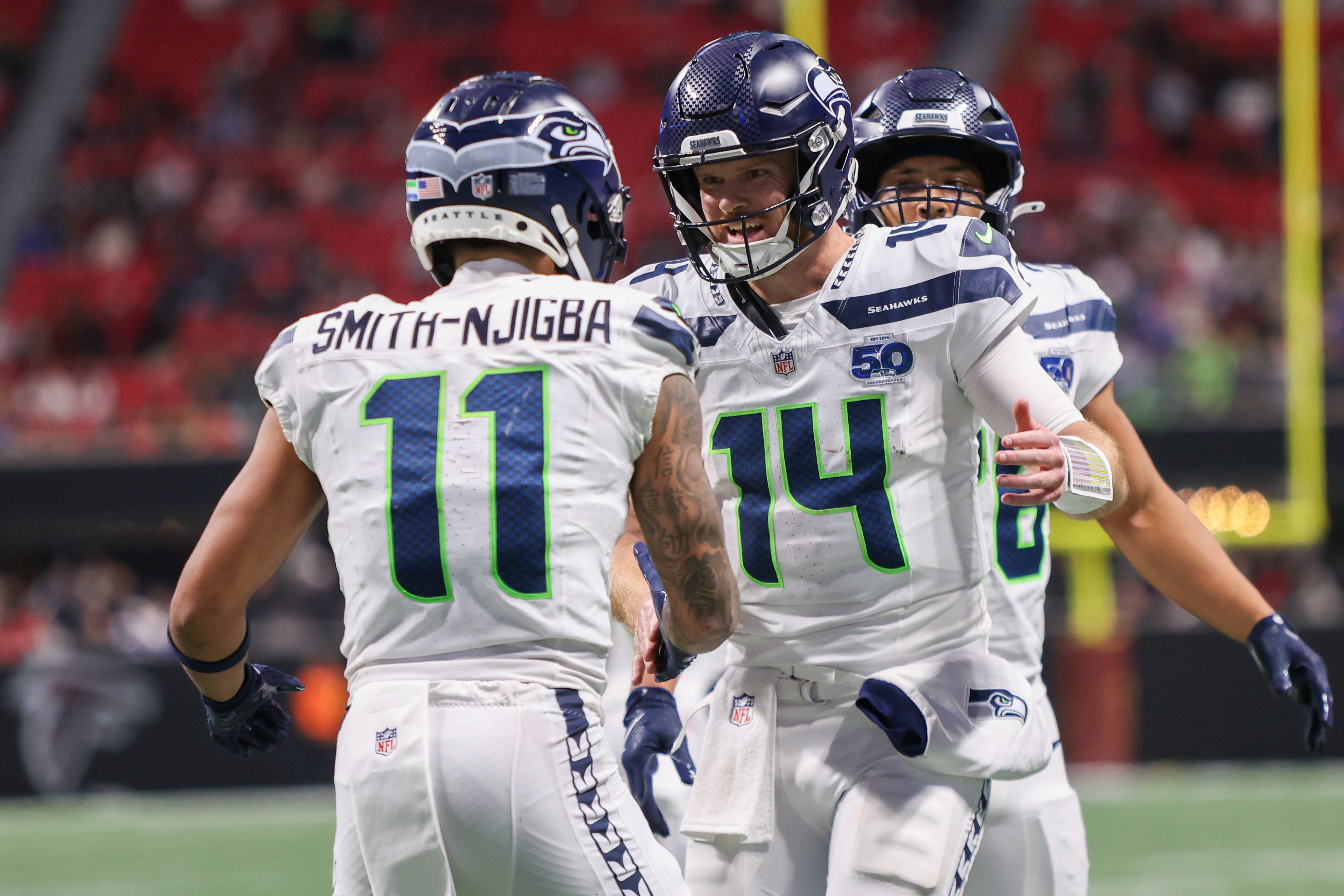 Seattle Seahawks quarterback Sam Darnold (14), who is featured in our NFL contract incentives tracker, celebrates with wide receiver Jaxon Smith-Njigba (11).
