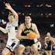 Zach Edey of the Purdue Boilermakers handles the ball while being guarded by Donovan Clingan of the UConn Huskies in the NCAA Men's Basketball Tournament National Championship game. Edey was the favorite by the 2024 Wooden Award odds all season. 