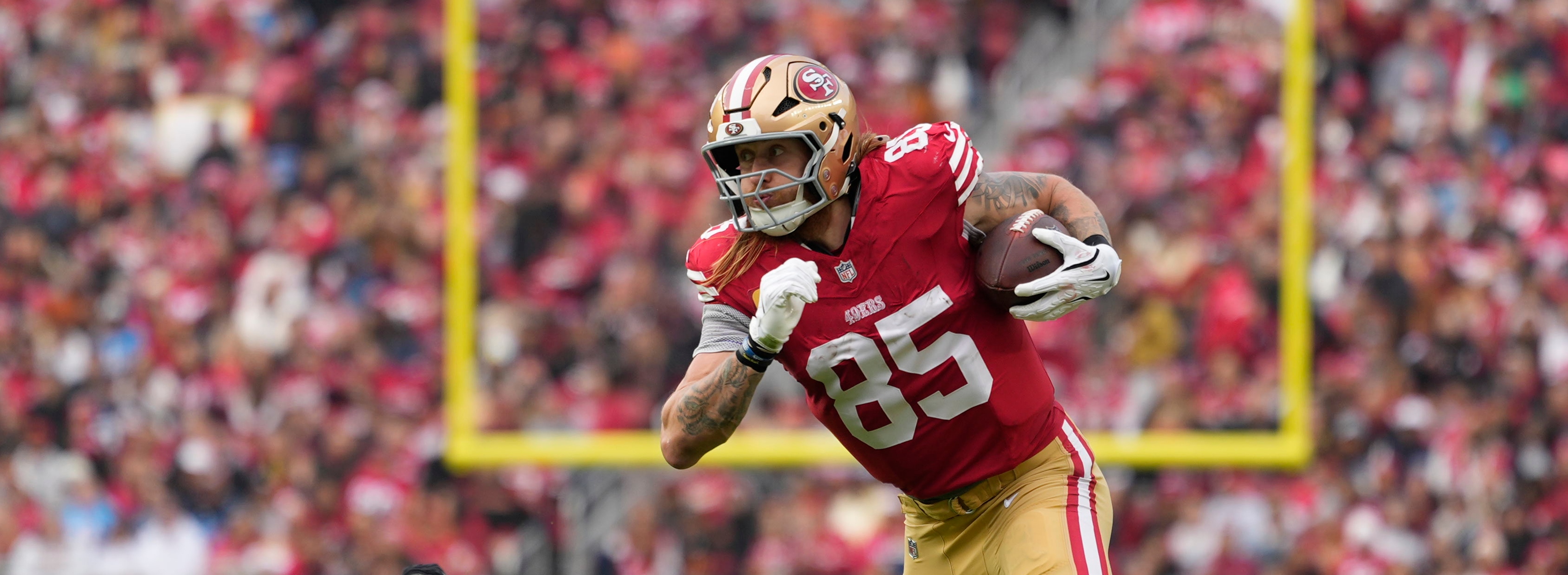 San Francisco 49ers tight end George Kittle (85) runs the ball against Tennessee Titans safety Kendell Brooks (30) during the second quarter at Levi's Stadium