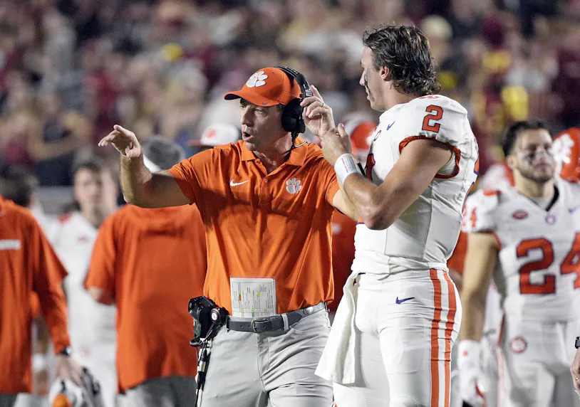 Clemson Tigers head coach Dabo Swinney talks with quarterback Cade Klubnik as we offer our Clemson vs. Wake Forest prediction for Saturday's Week 7 college football matchup.