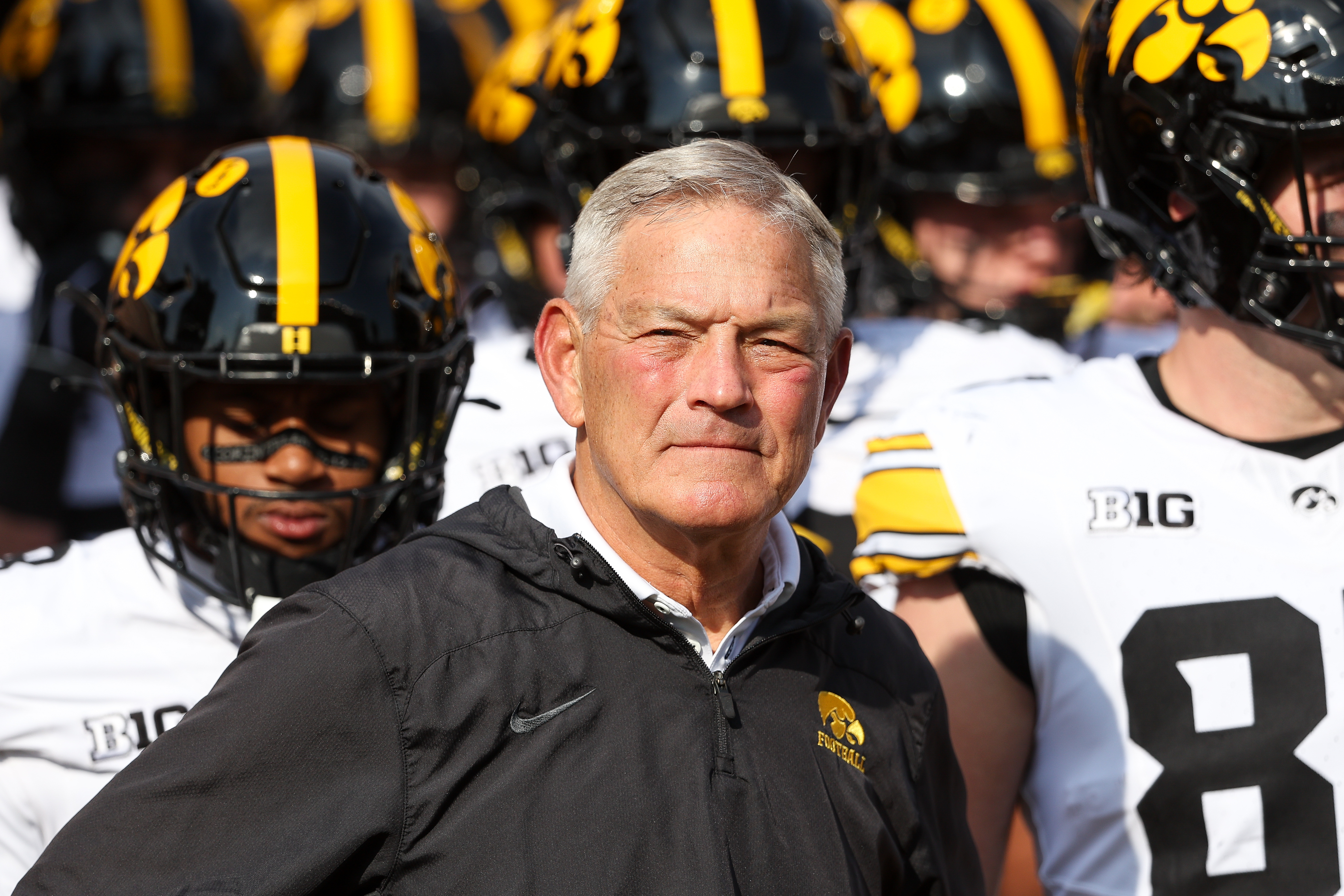 Iowa Hawkeyes head coach Kirk Ferentz leads his team onto the field as he is featured in our Wisconsin vs. Iowa prediction.