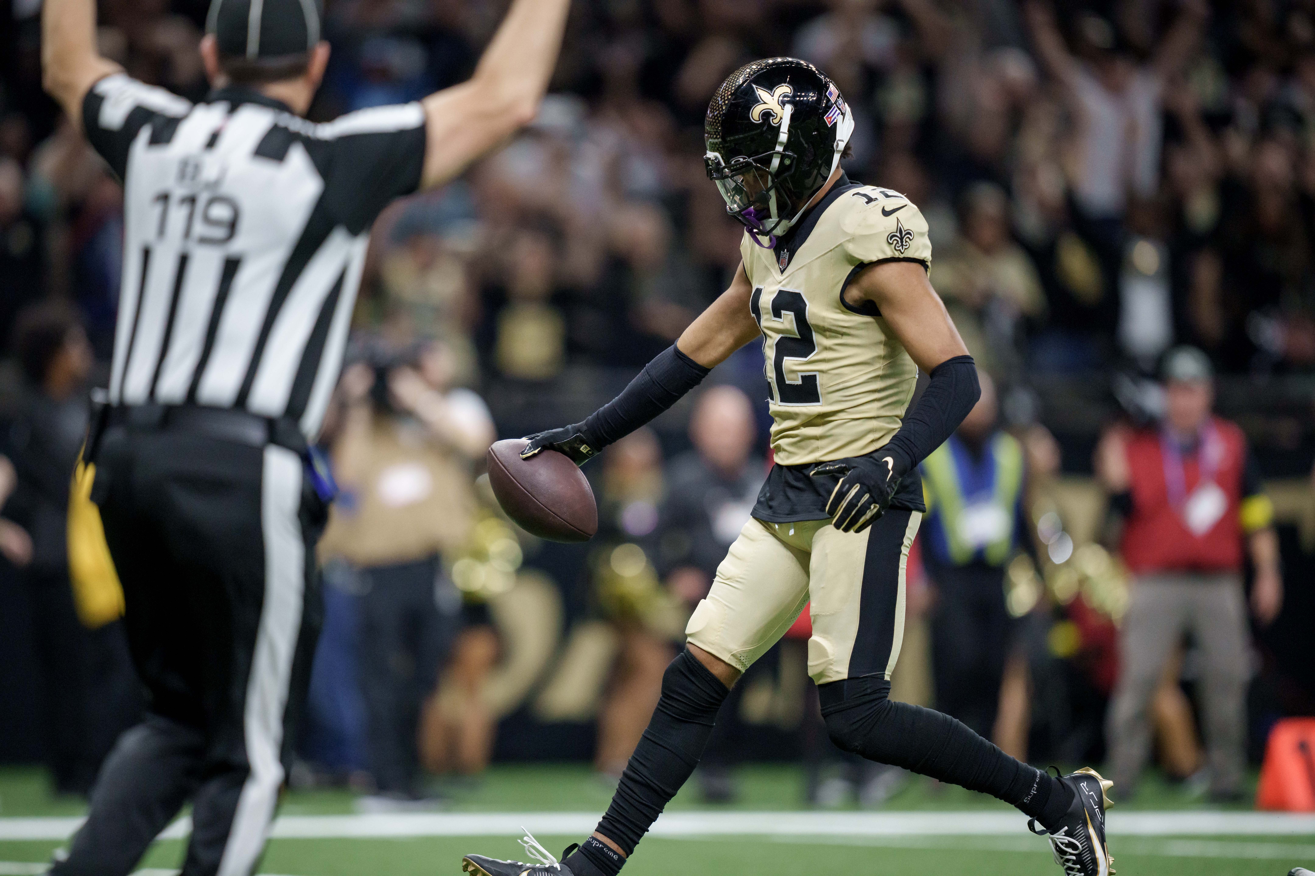 New Orleans Saints wide receiver Chris Olave (12) scores a touchdown as we offer our anytime touchdown scorer parlay for NFL Week 17.
