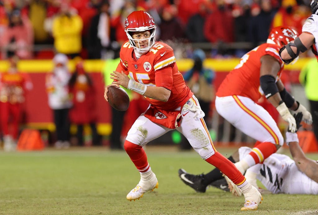 Patrick Mahomes #15 of the Kansas City Chiefs looks to pass against the Cincinnati Bengals during the fourth quarter in the AFC Championship Game at GEHA Field at Arrowhead Stadium on January 29, 2023 in Kansas City, Missouri. Photo by Kevin C. Cox/Getty Images via AFP.
