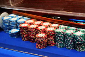 Chips are piled up on a craps table as we look at Massachusetts casino and sportsbook revenue for August 2024.