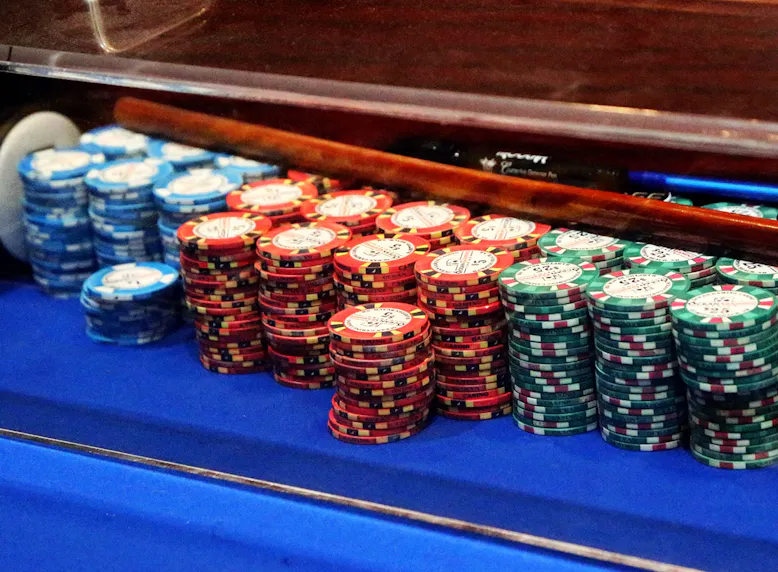 Chips are piled up on a craps table as we look at Massachusetts casino and sportsbook revenue for August 2024.
