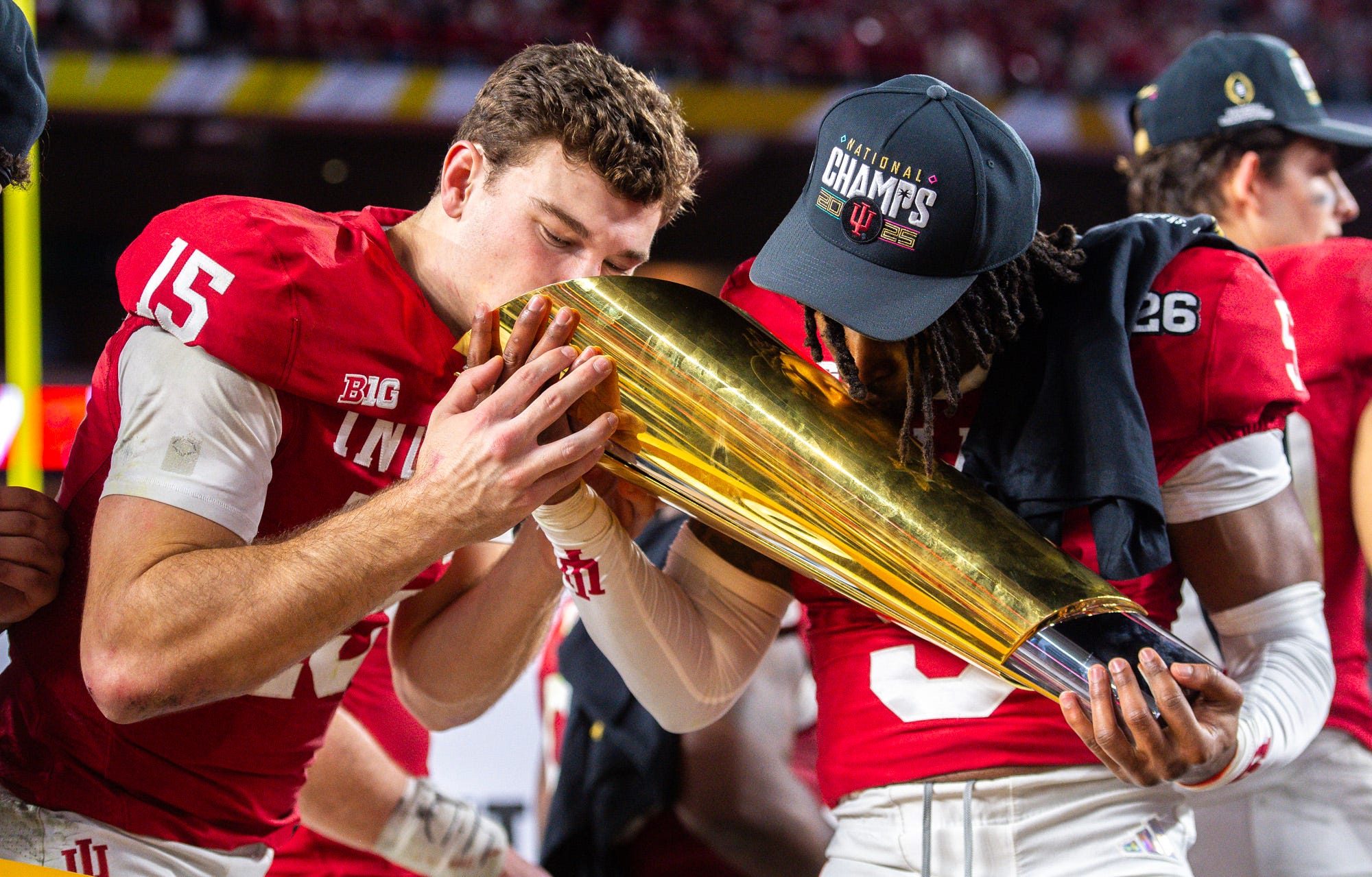 Indiana's Fernando Mendoza and D'Angelo Ponds kiss the  College Football Playoff National Championship trophy as we look at the deal between On3 and Polymarket.