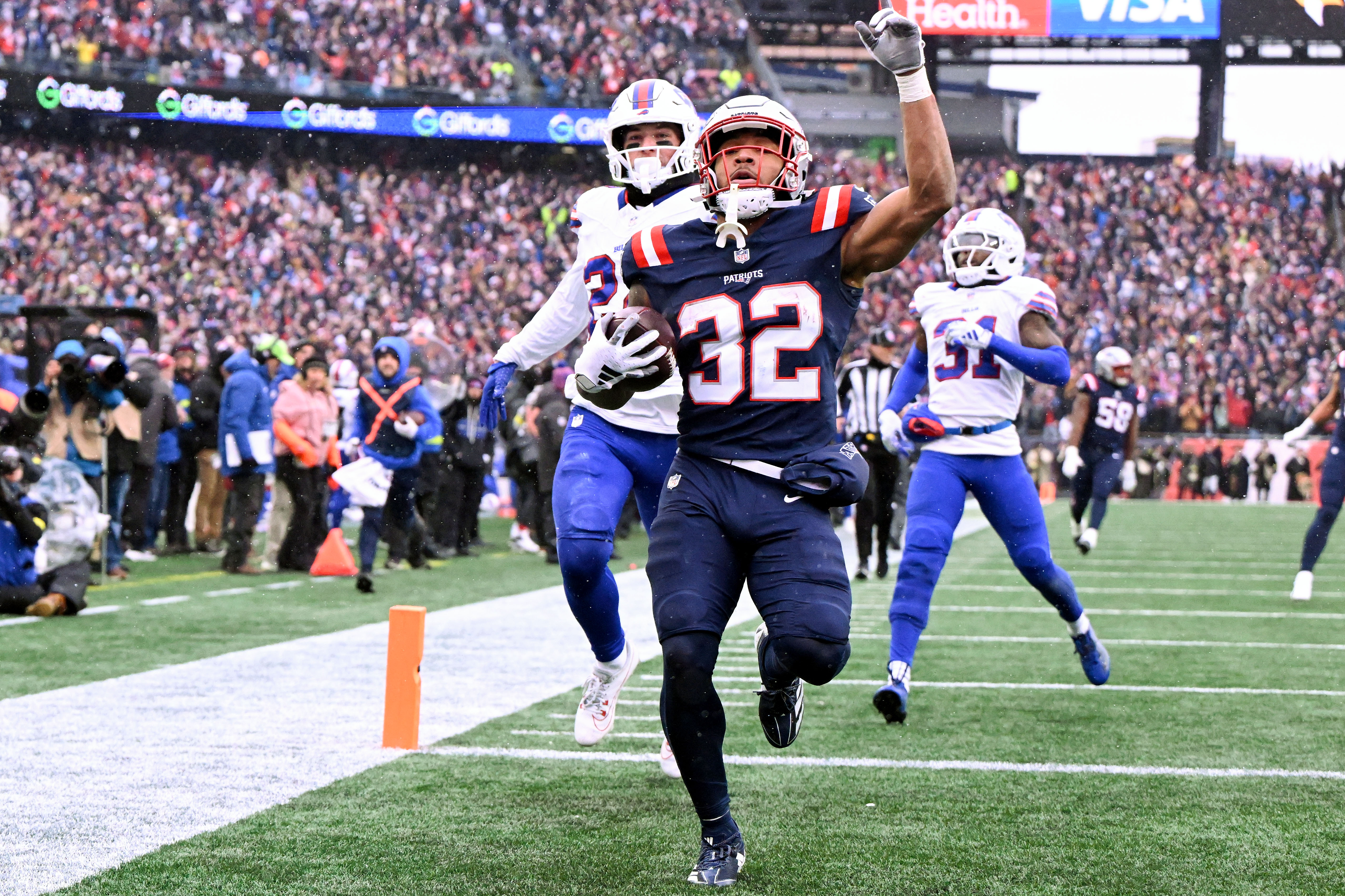 New England Patriots running back Treveyon Henderson scores a touchdown as we make our best Patriots vs. Ravens prediction
