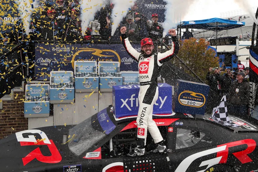 NASCAR Xfinity Series driver Ryan Truex celebrates in victory lane after winning the BetRivers 200 at Dover Motor Speedway as we look at BetRivers' decision not to implement a surcharge on winning bets.
