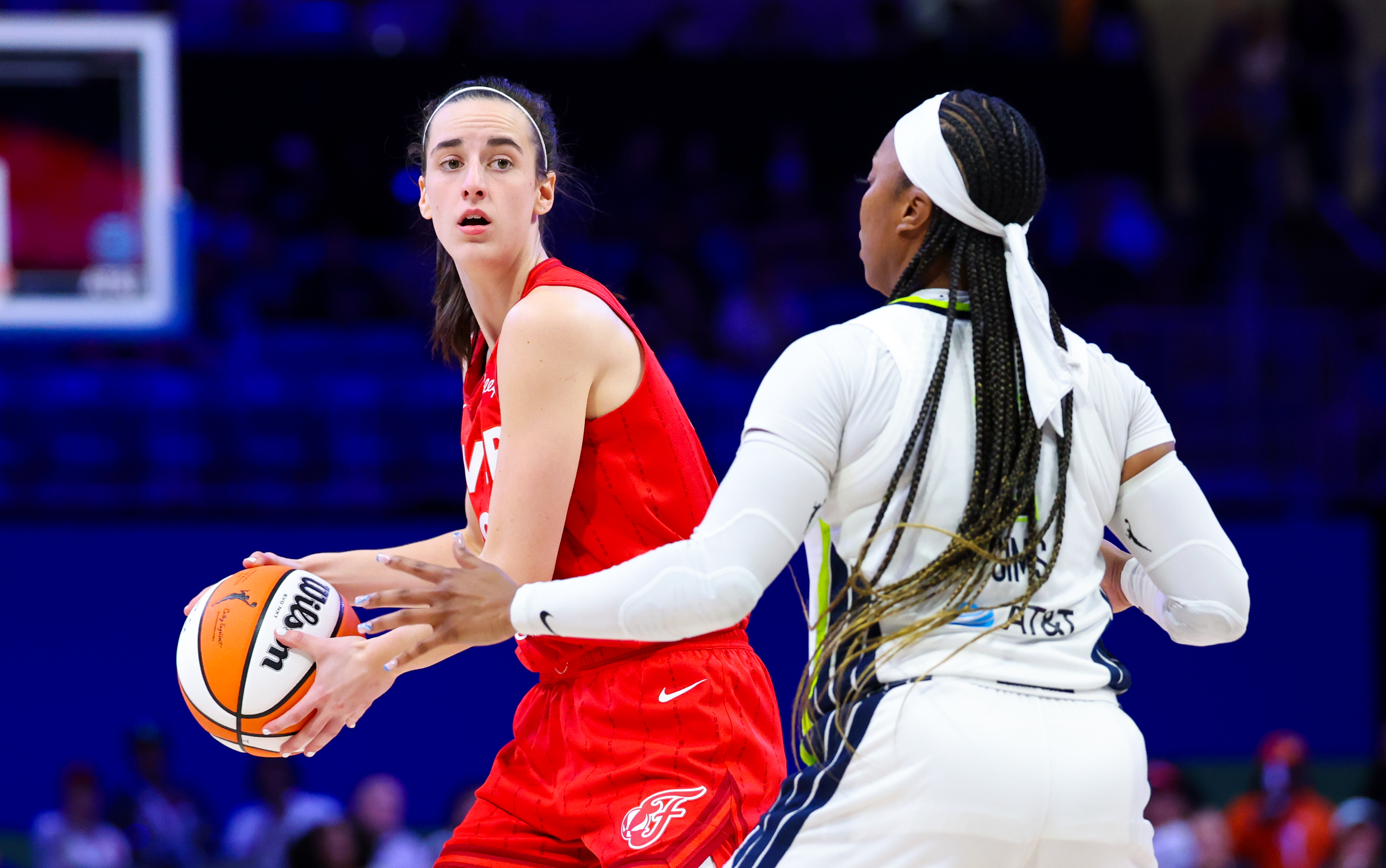 Indiana Fever guard Caitlin Clark (22) looks to pass as we offer our best Fever vs. Wings prediction and expert picks for Sunday's WNBA matchup at College Park Center in Arlington, Texas.