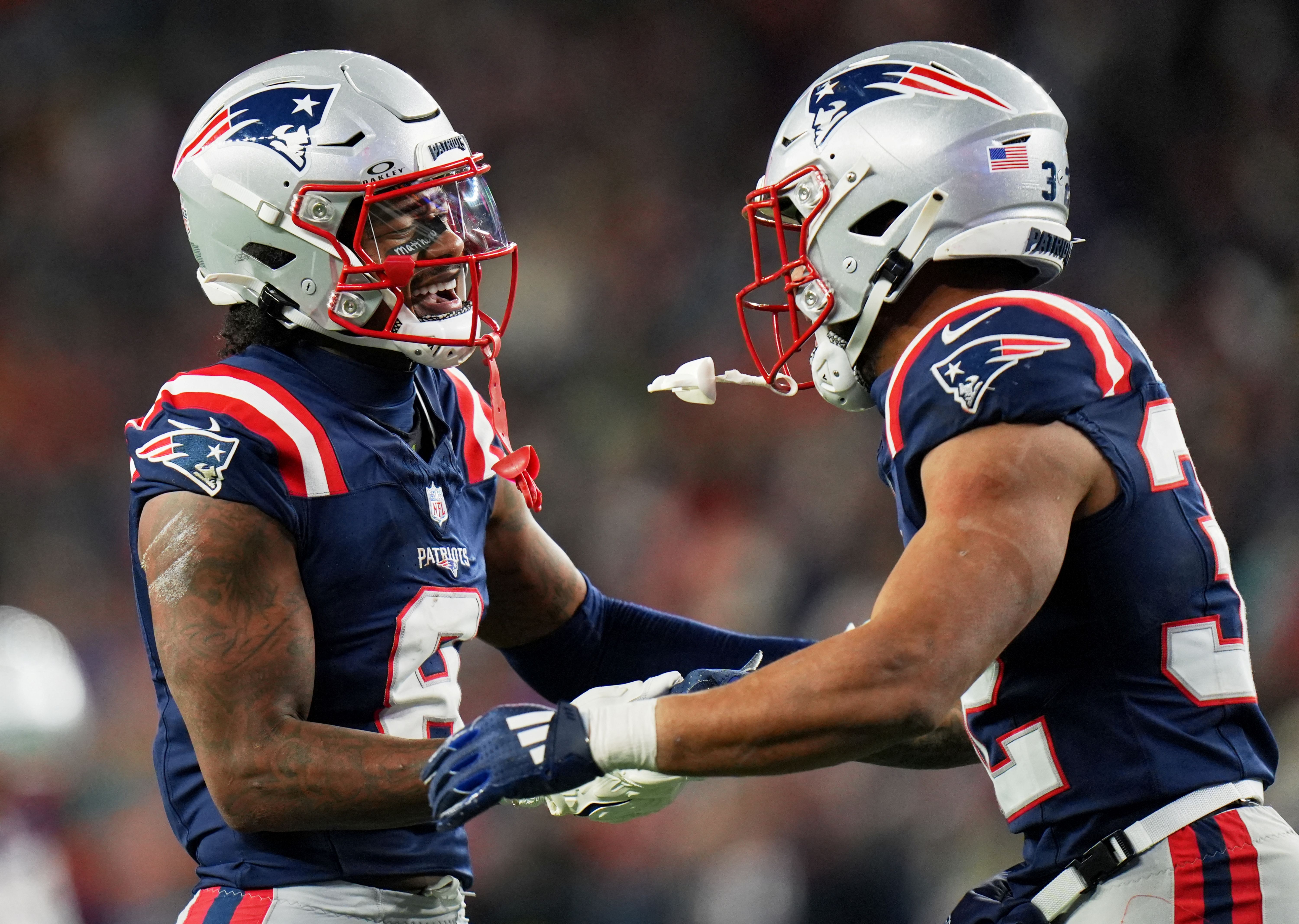 New England Patriots wide receiver Stefon Diggs celebrates with running back TreVeyon Henderson as we look at the Chargers vs. Patriots weather report.