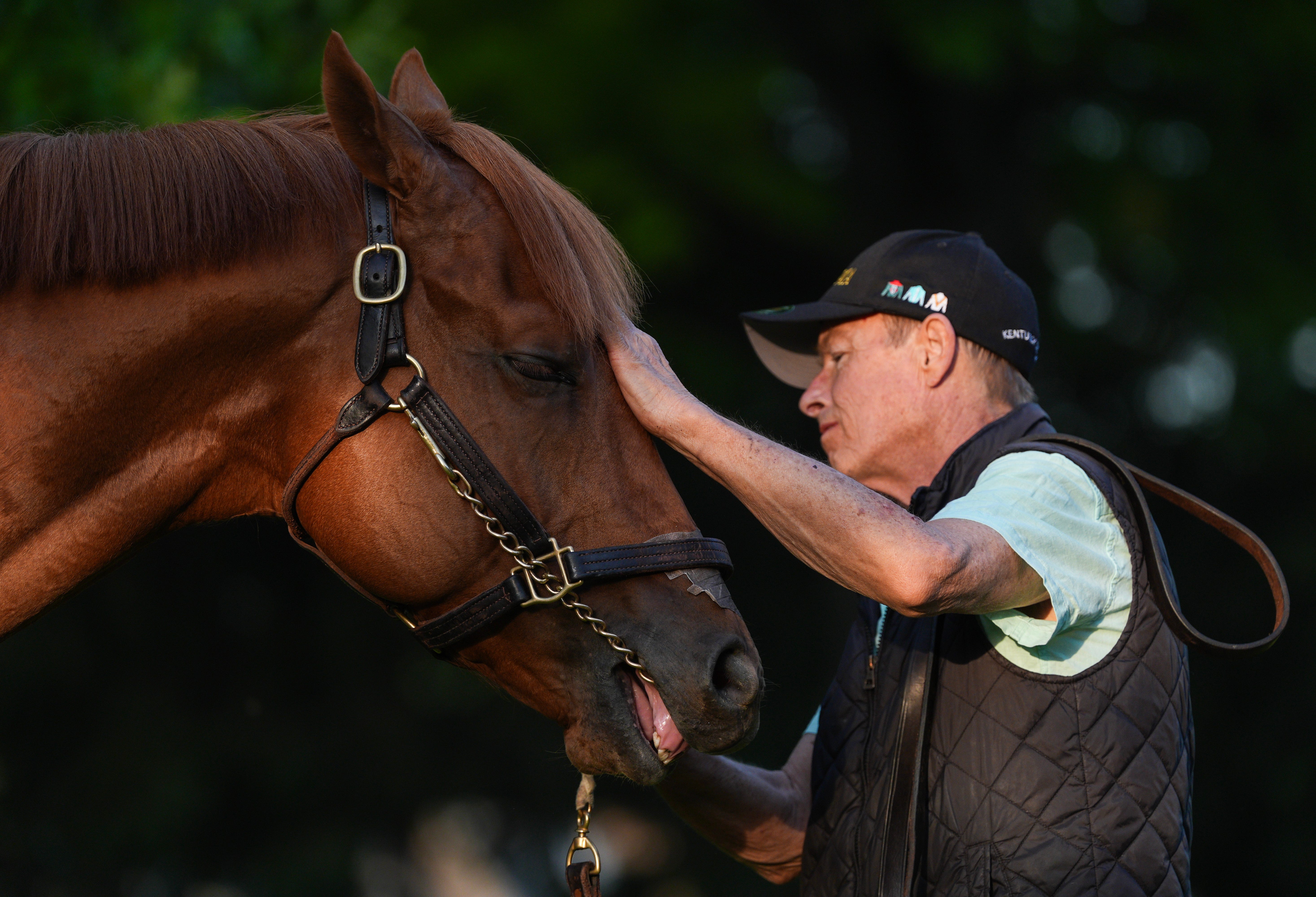 2026 Kentucky Derby horse The Puma stands outside his barn with walker Brian Fitzgerald after morning training at Churchill Downs in Louisville, Kentucky.