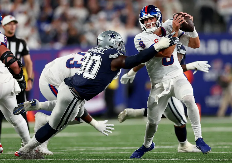 Daniel Jones #8 of the New York Giants scrambles against DeMarcus Lawrence #90 of the Dallas Cowboys during the second quarter in the game at MetLife Stadium on Sept. 26.