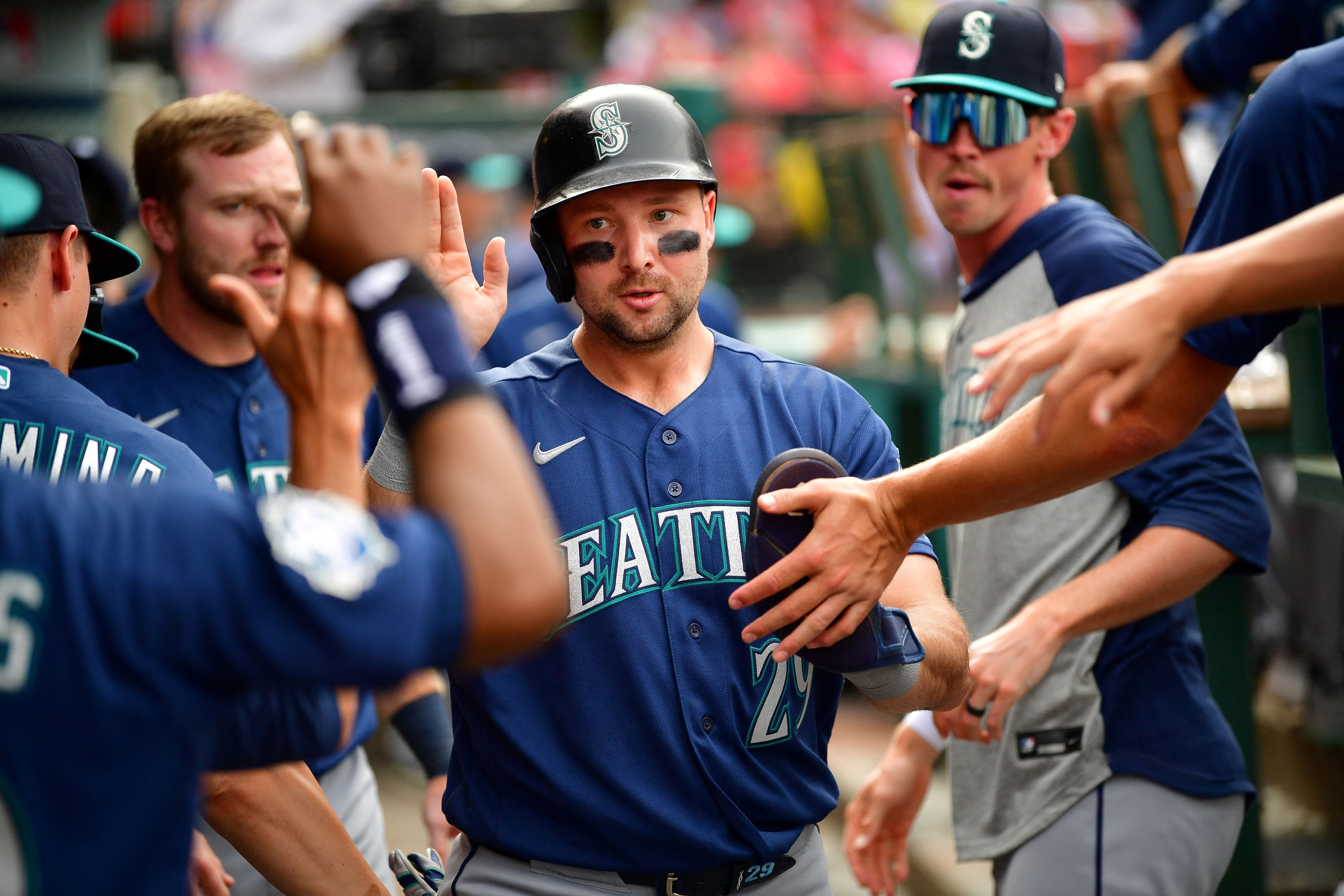 Seattle Mariners designated hitter Cal Raleigh is greeted after scoring a run, and he's featured in my home run predictions today.