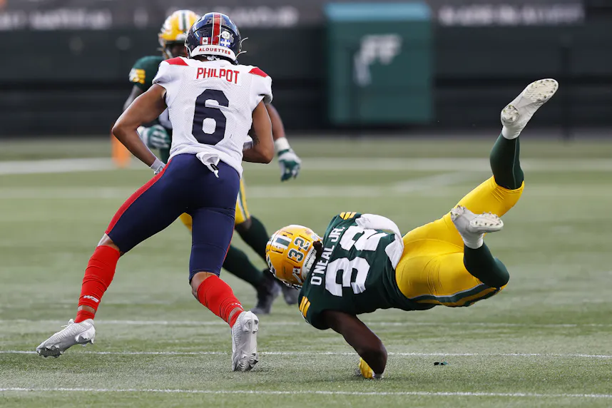 Edmonton Elks defensive back Leon O'Neal Jr. dives to tackle Montreal Alouettes wide receiver Tyson Philpot. We're backing Montreal in our Alouettes vs. Tiger-Cats Prediction.