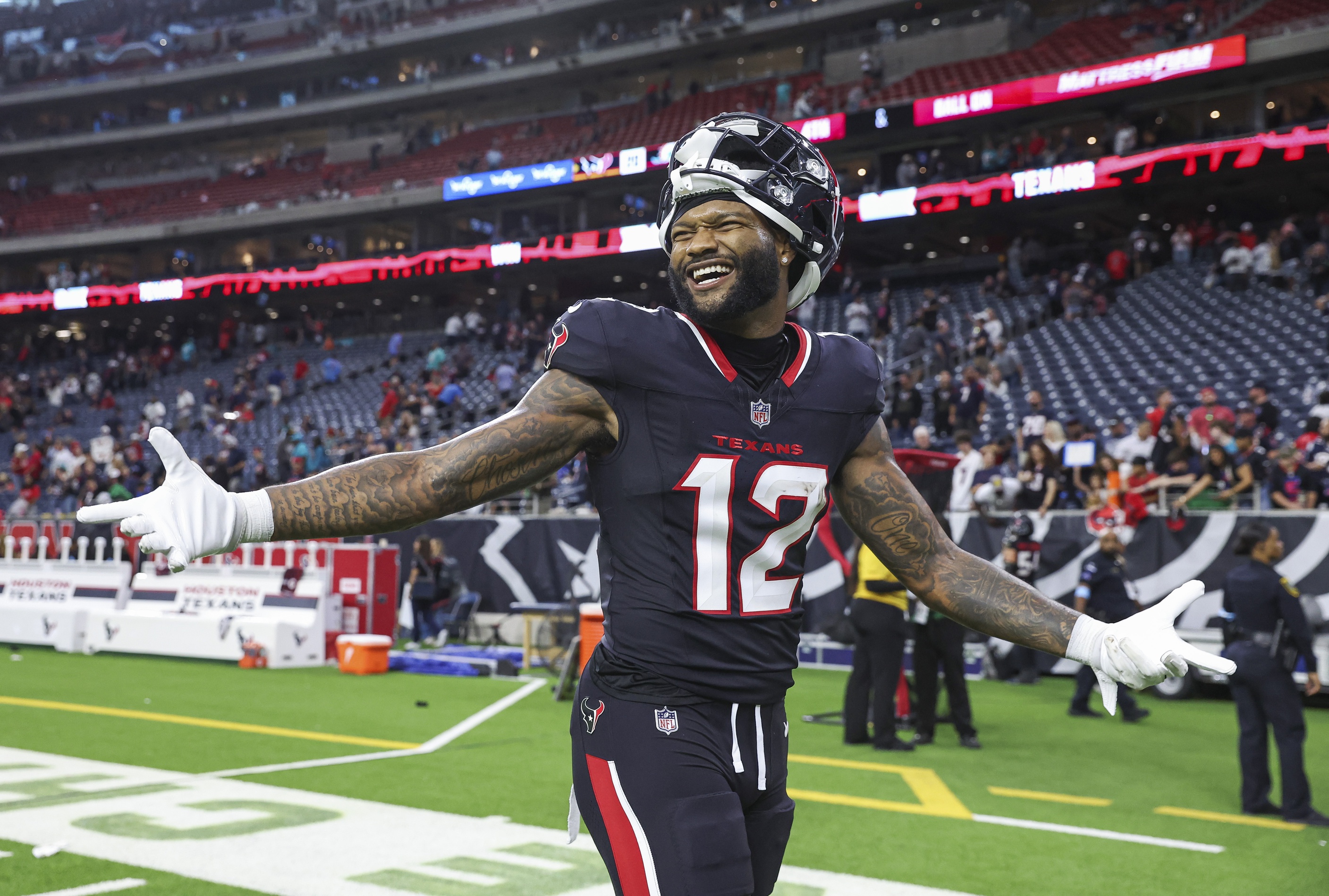 Houston Texans wide receiver Nico Collins smiles after a game, and he's central to our Texans vs. Chargers predictions