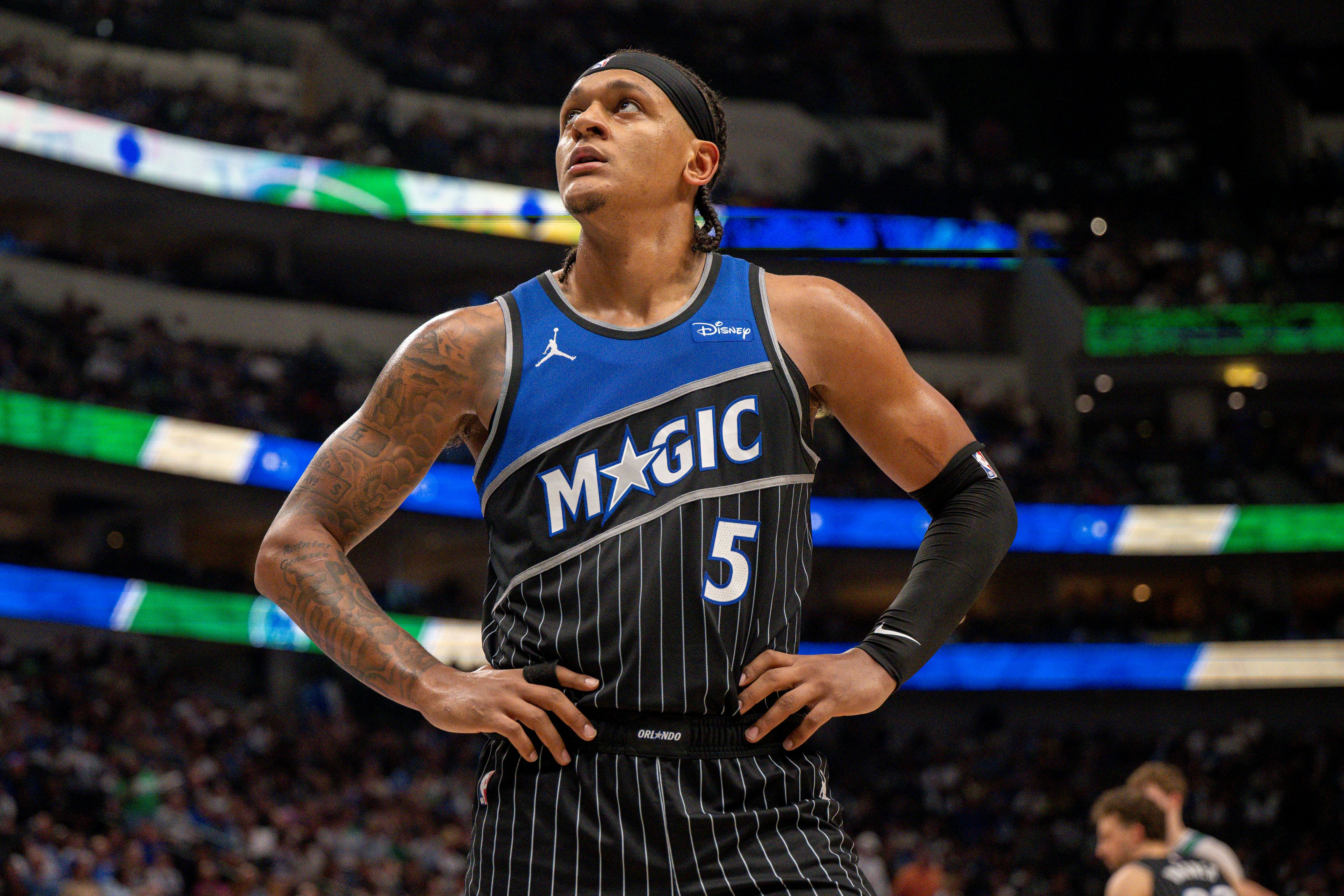 Orlando Magic forward Paolo Banchero (5), seen here looking on during a game, is featured in our Magic vs. 76ers prediction.