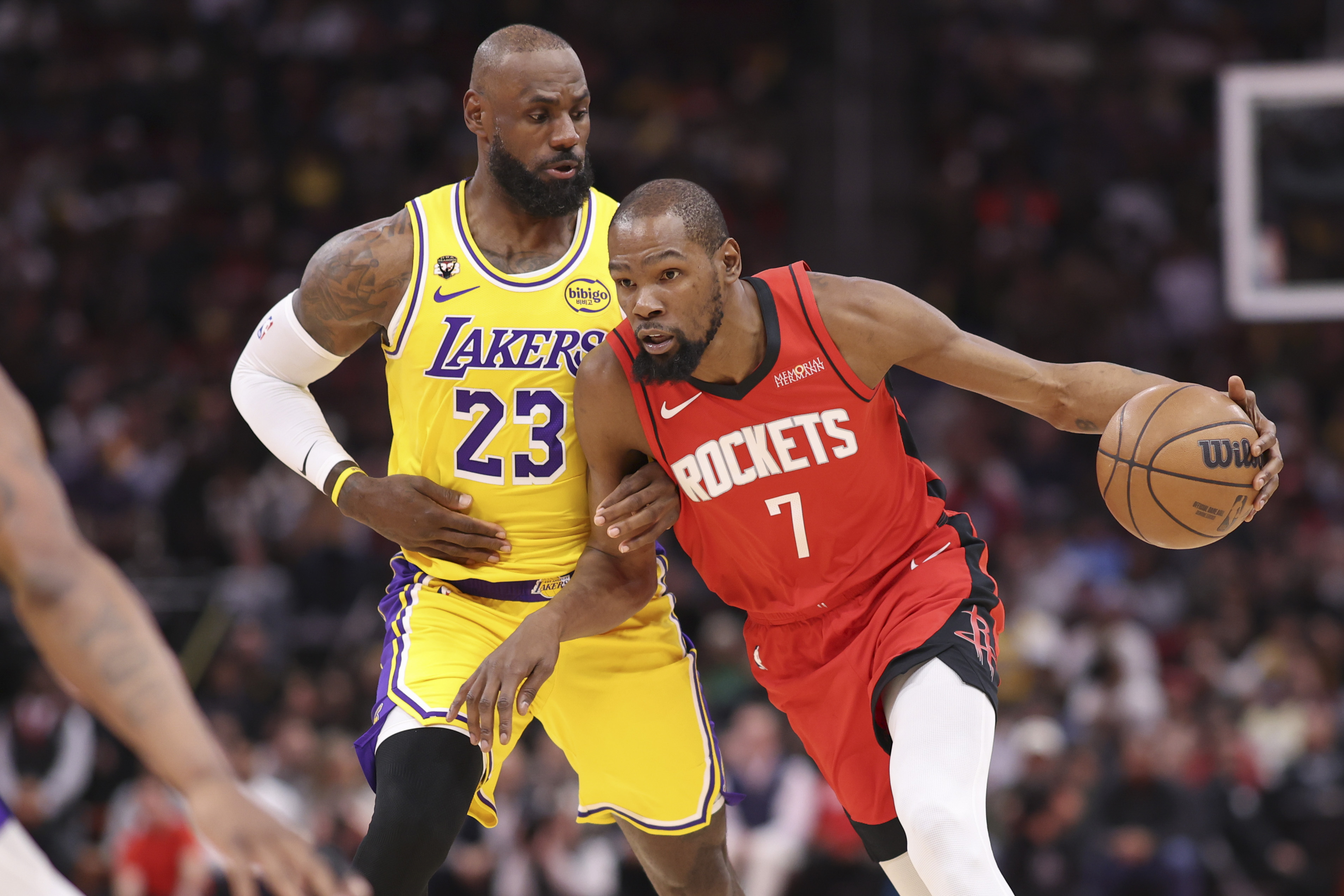 Houston Rockets forward Kevin Durant (7) dribbles the ball as Los Angeles Lakers forward LeBron James (23) defends during the first quarter at Toyota Center.