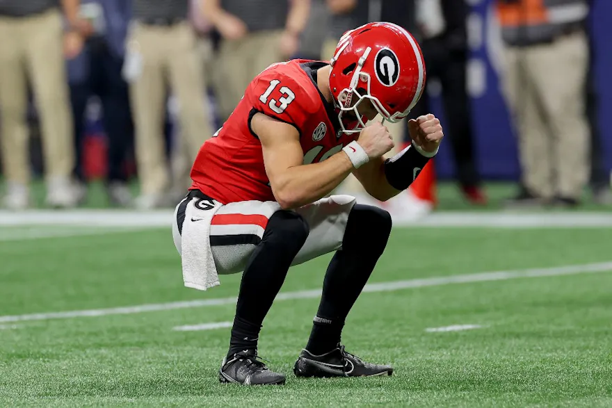 Stetson Bennett of the Georgia Bulldogs celebrates a touchdown against the LSU Tigers during the third quarter in the SEC Championship game at Mercedes-Benz Stadium on December 03, 2022 in Atlanta, Georgia.