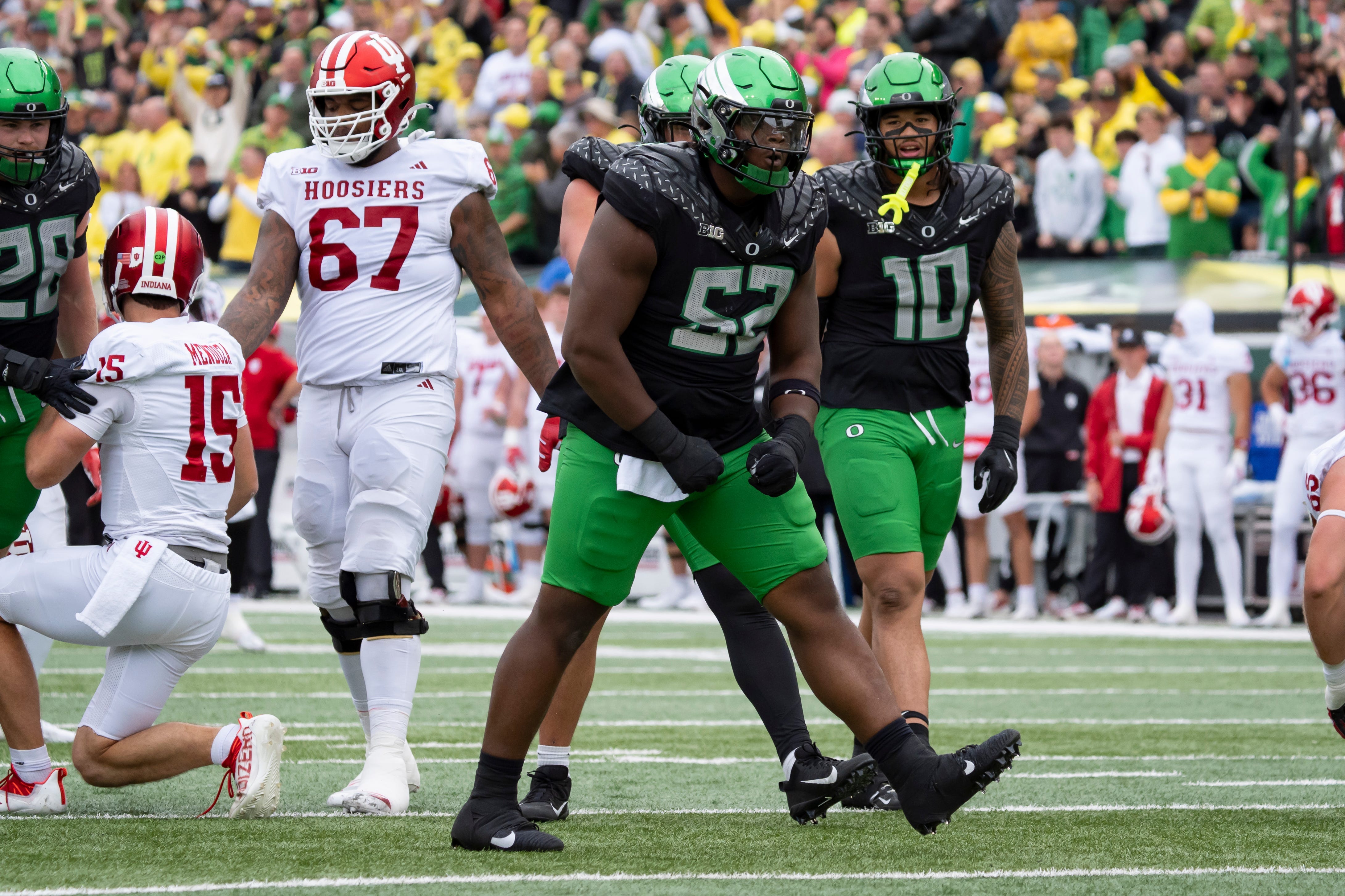 Oregon defensive lineman A'Mauri Washington celebrates a sack as we break down the CFP semifinal look-ahead odds and hypothetical betting lines for the College Football Playoff.