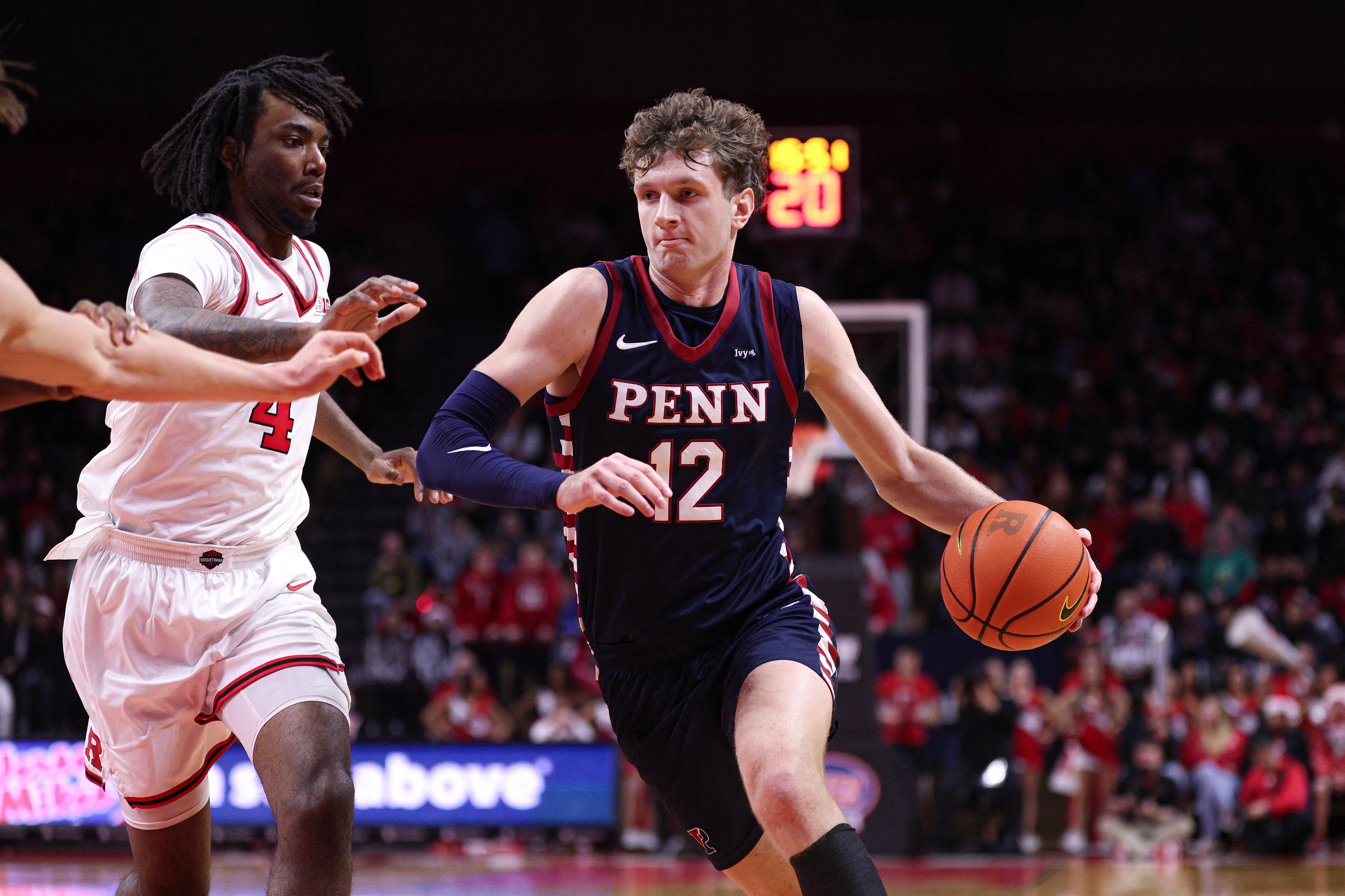 Penn Quakers forward TJ Power goes to the basket as we make our Penn vs. Yale Ivy League Championship prediction.