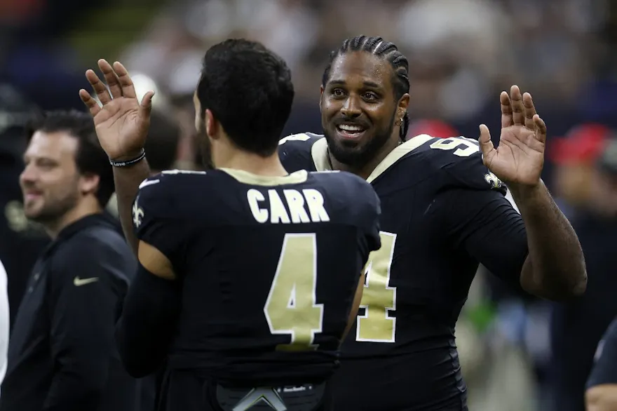 Cameron Jordan #94 of the New Orleans Saints talks with Derek Carr #4 as we look at our Saints-Panthers predictions