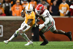 Tennessee quarterback Joe Milton III is defended by Georgia defensive lineman Mykel Williams during a football game between Tennessee and Georgia. Georgia leads the 2025 College Football Championship Odds. 