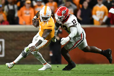 Tennessee quarterback Joe Milton III is defended by Georgia defensive lineman Mykel Williams during a football game between Tennessee and Georgia. Georgia leads the 2025 College Football Championship Odds. 