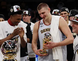 Nikola Jokic of the Denver Nuggets celebrates with teammates. Jokic will play for Serbia as we look at the Men's Olympic Basketball odds.