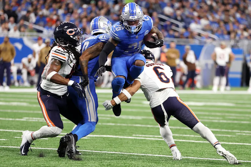 Jahmyr Gibbs of the Detroit Lions leaps his way into our Week 13 NFL predictions for Lions vs. Saints