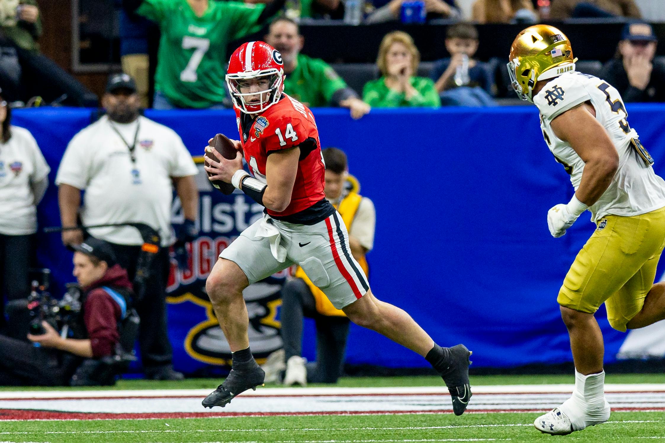 Georgia Bulldogs quarterback Gunner Stockton scrambles out of the pocket, as we offer our Georgia football 2025 season preview with way-too-early predictions, odds, and schedule.