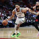 Jayson Tatum #0 of the Boston Celtics drives against Caleb Martin #16 of the Miami Heat as we look at our Heat vs. Celtics Game 1 NBA player props