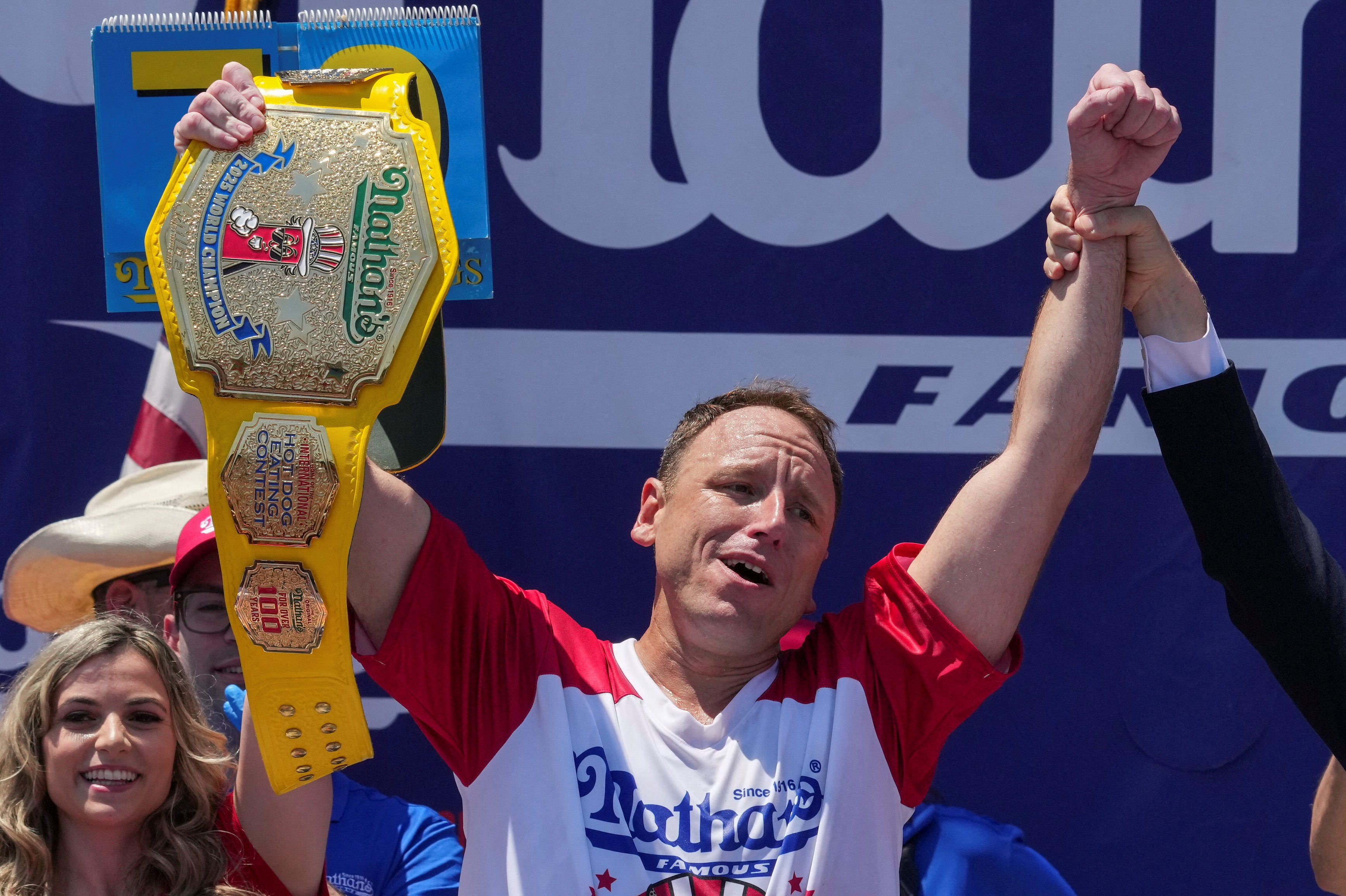 Joey Chestnut, a multi-time winner, holds the Mustard Belt, after winning the competition during the 2025 Nathan's Famous International Hot Dog Eating Contest at Coney Island, Brooklyn in New York City, U.S.